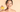 Woman smiling and squeezing an orange